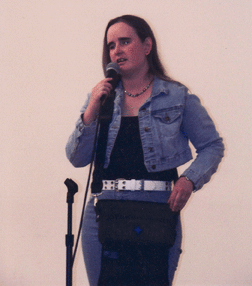 Kelly Burma sings on stage at the Albuquerque Museum of Art in a program celebrating Art Beyond Sight Awareness Day.