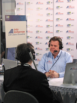 While at the Consumer Electronics Showcase, Mark Riccobono, executive director of the Jernigan Institute, was interviewed on the Into Tomorrow radio show by host Dave Graveline. Mark, his back to the camera, and Dave, facing the camera, can be seen here with microphones and headsets.
