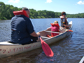 Life 101 students and staff paddle a canoe.