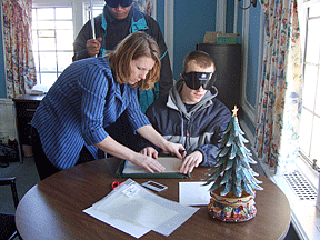 Lori Brown works with CJ Wallace on handwriting.