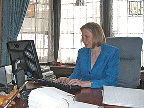 Shawn Mayo at her desk in the library of the Pillsbury mansion