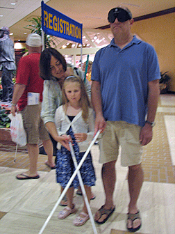 Vicki Buchignani instructs Rio Popper from California in the proper placement of her white cane. Her father Doug, cane in hand, listens to the lesson.