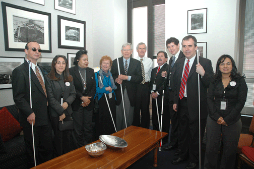 Seated around a table in New Mexico Senator Jeff Bingaman&rsquo;s office, left to right, are Fred Schroeder, Joni Martinez, Wanda Briggs, NFB of New Mexico President Christine Hall, Arthur Schreiber, Senator Bingaman, Ray Marshall, Wesley Peters, James McCarthy, and Claudia Martinez.
