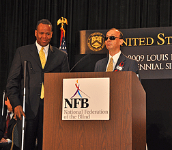 Fred Schroeder (at the podium) prepares to present the NFB�s report on Braille to presidential advisor Kareem Dale.