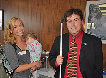 Mark Riccobono, executive director of the NFB Jernigan Institute, chats with Amber Evans, a parent attending the Beginnings and Blueprints Early Childhood Conference. Amber is holding her daughter Makynna.