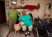 Jim and Lynda Canaday and their dog Darby in the living room of their home