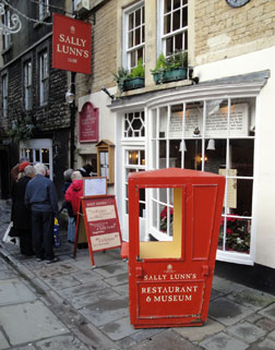Entrance to the Sally Lunn restaurant with a Victorian sedan chair on display