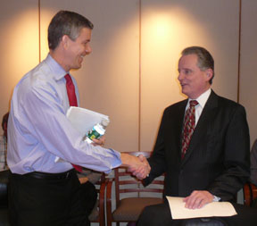 NFB President Marc Maurer and U.S. Secretary of Education Arne Duncan shake hands at the beginning of the book presentation ceremony.
