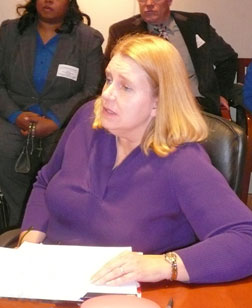 Dr. Denise Colton, a mother of two blind children, delivers remarks while seated at the U.S. secretary of education's conference table.