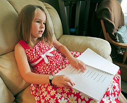 Alyana Hall enjoys reading a Braille book. She and her team, the Braille Power Puffs, were one of the winners of the Braille Readers Are Leaders Team of the Year Award in 2009/2010.
