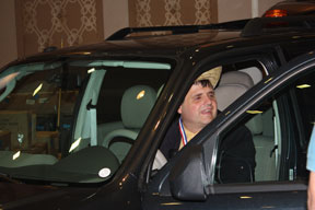 NFB board member John Fritz sits in the Ford Escape that will be fitted with technology allowing it to be driven by a blind person.