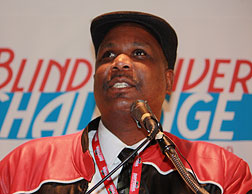 Anil Lewis speaks at the podium during the Blind Driver Challenge�.