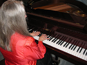 Donna Hill is shown playing the piano