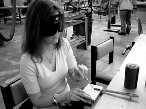 Chelsea Mu&ntilde;oz uses a click rule and a scratch awl as she works on her grid block.