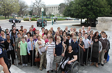 LAW program participants, parents, and mentors pose for a photo with a House office building in the background.