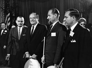 Left to right Russell Kletzing, NFB president; Hubert Humphrey, vice president of the United States; Dr. tenBroek; and Kenneth Jernigan pose at the 1965 NFB national convention banquet.
