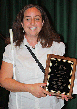 Angela Wolf holding her plaque