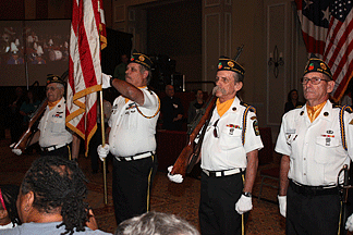 The color guard stands at attention as our fifty blind veterans introduce themselves and gather on stage.