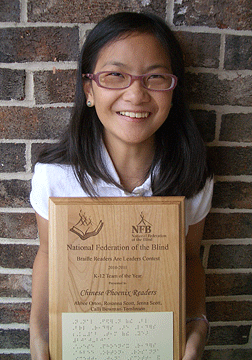 Ahbee Orton, captain of the Chinese Phoenix Readers, poses with the plaque her team received after winning the 2010-2011 Braille Readers Are Leaders Team of the Year Award. The three other girls on the team were: Rosanna Scott, Jenna Scott, and Calli Bowman-Tomlinson.