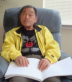 Al Maneki reading Braille