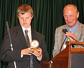 Hoby Wedler holding his award stands with Jim Gashel.
