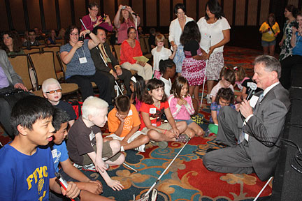 Early in the NOPBC day of activities each year, President Maurer sits down with the kids to answer questions about blindness. During the discussion this year a charming little girl was eager to teach him to play her favorite game.