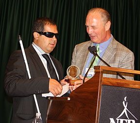 Richie Flores receives his award from Jim Gashel.
