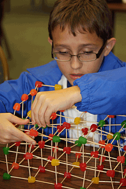 Braiden Lee builds a candy bridge