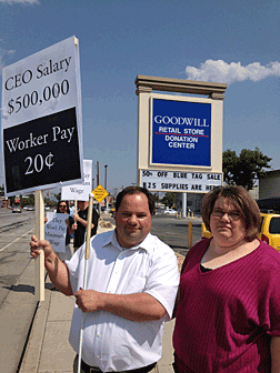 Brian and Cindy Dulude of Utah take part in a protest outside a Goodwill donation center.