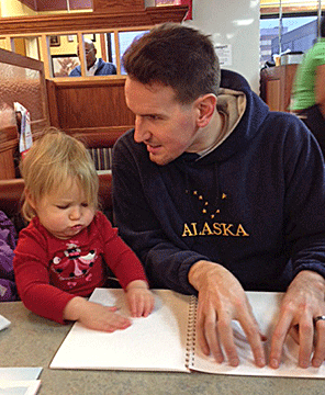 Jesse Hartle reads with his two-year-old daughter, Kayla. You�re never too young to appreciate Braille.