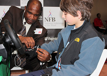 Anil Lewis helps a pre-teen boy put on the BDS gloves.