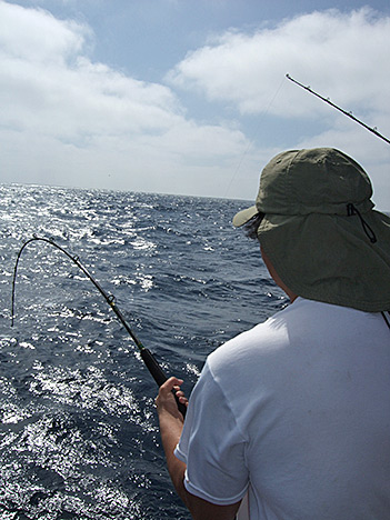 Gordon fights the pull of the tuna on his line.
