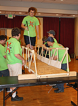 Alexander Richmond walks across the bridge he built with his peers in the civil engineering class to prove its strength.