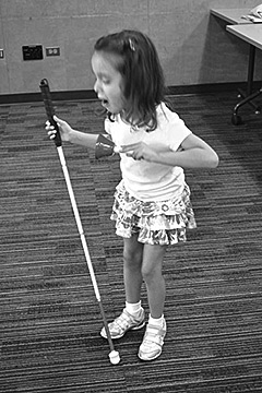 Mikayla rings her bell at the Colorado BELL Program