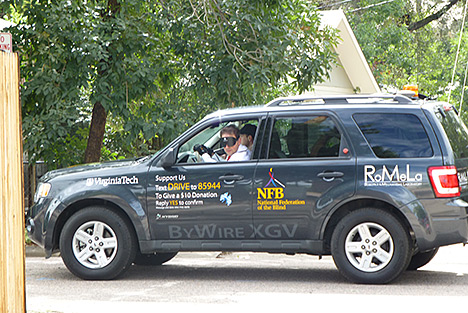 Blind driver, Mark A. Riccobono, takes celebration attendees for a spin in the NFB�s Blind Driver Challenge car.