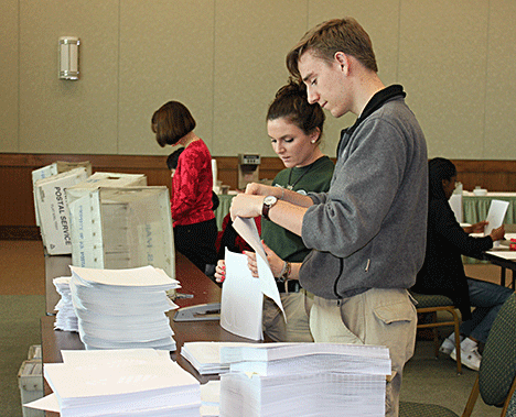 Two volunteers from AmeriCorps NCCC prepare an educational mailing.