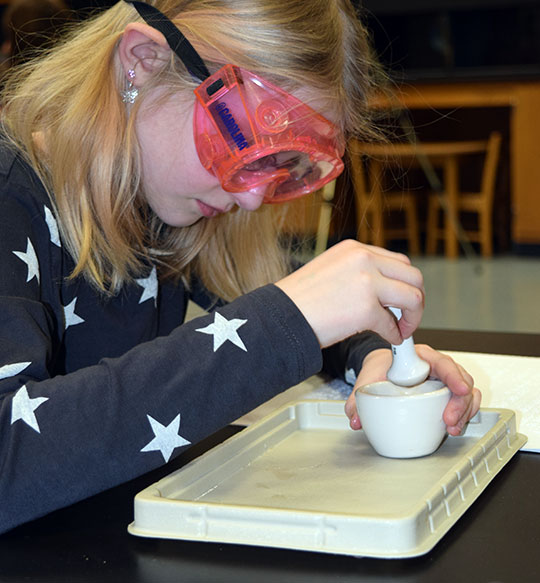 Isabella Cherin uses a mortar and pestle.