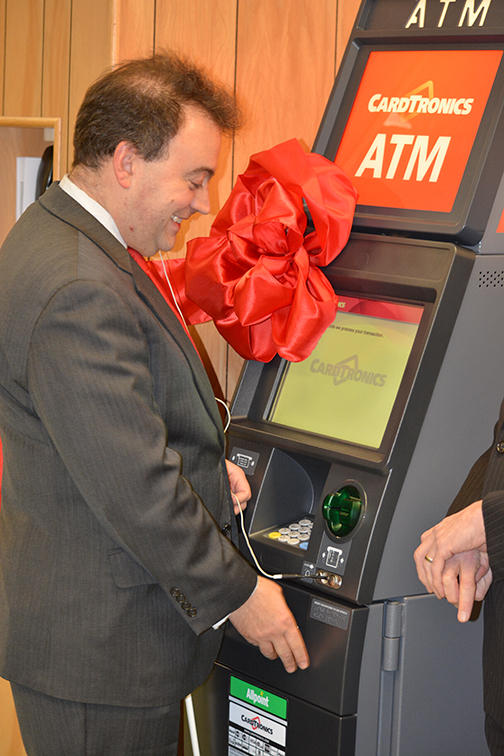 Mark Riccobono receives his cash as he makes the first withdrawal from the new ATM.