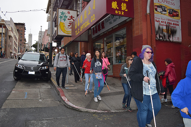A group of students navigate on a trip to Chinatown.
