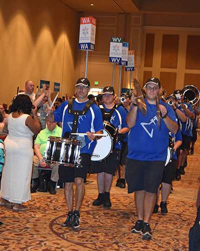 Impact Drum and Bugle Corps of Orlando marches through the convention hall.