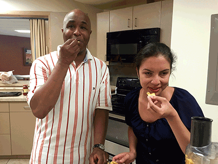 Dishon and Marisol eating hummus