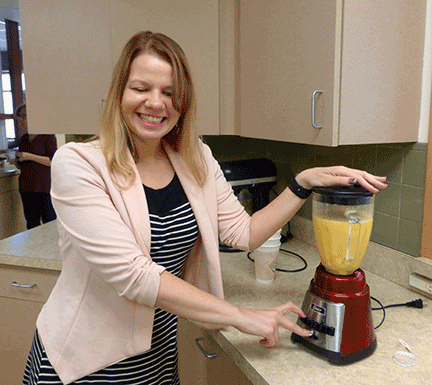 Maureen at the blender with a batch of Go Broncos Orange Julius