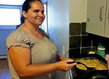 Michelle stirring an electric skillet of Chacon&rsquo;s Green Chile