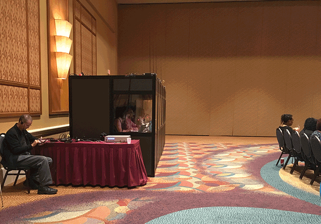 The enclosed booth where the translators work at the back of the WBU meeting room.