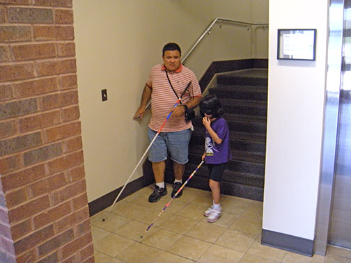 EmmaGrace and her blind mentor Raul take the stairs.