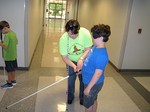 Liz Wisecarver helps Brendan learn cane travel at the Houston BELL Academy.
