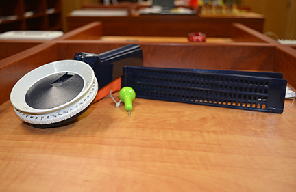 Shown here are a slate and stylus and a Braille label maker, two low-tech items that significantly contribute to the independence of the blind.