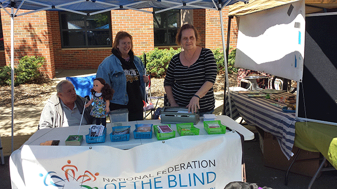 Chapter members Bruce Stockler, Cheryl Meister, and Debbie Wunder have the table set up and ready for business Sunday morning.