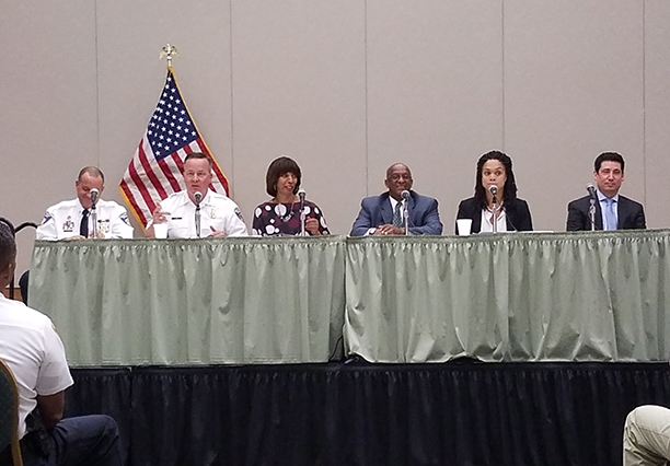 The panel on stage. From L to R: BPD Southern District Major Steve Ward, BPD Commissioner Kevin Davis, Mayor Catherine Pugh, City Council President Jack Young, State&rsquo;s Attorney for Baltimore City Marilyn Mosby, and State&rsquo;s Attorney&rsquo;s Office Chief of Juvenile Division Gavin Pataschnick.