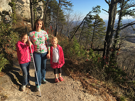 Louise and two of her girls, Miriam and Caitlin, are shown on their favorite hike at the top of Pilot Mountain in North Carolina.